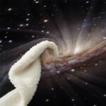 Soft galaxy-themed blanket featuring a stunning cosmic design with stars and nebulae, perfect for space enthusiasts and adding a celestial touch to your home decor.
