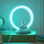 Neon ring lamp with a cute dinosaur figurine on a textured base, creating a modern and playful decor piece perfect for science-themed rooms or educational spaces.