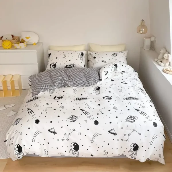Astronaut and planet-themed bedding set for kids' bedroom, featuring a white duvet cover with black space motifs including rockets, planets, stars, and astronauts, creating a fun and educational space.