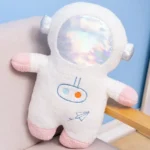 Soft astronaut plush toy with a reflective mirror face, pink and white accents, and embroidered space-themed details, perfect for educational play and decor.