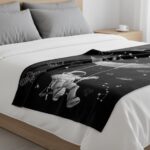 Black bed cover featuring white astronaut and space-themed illustrations, perfect for science enthusiasts and space lovers.
