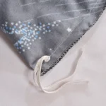 Brightly decorated fabric with star and dot patterns, featuring a white drawstring.