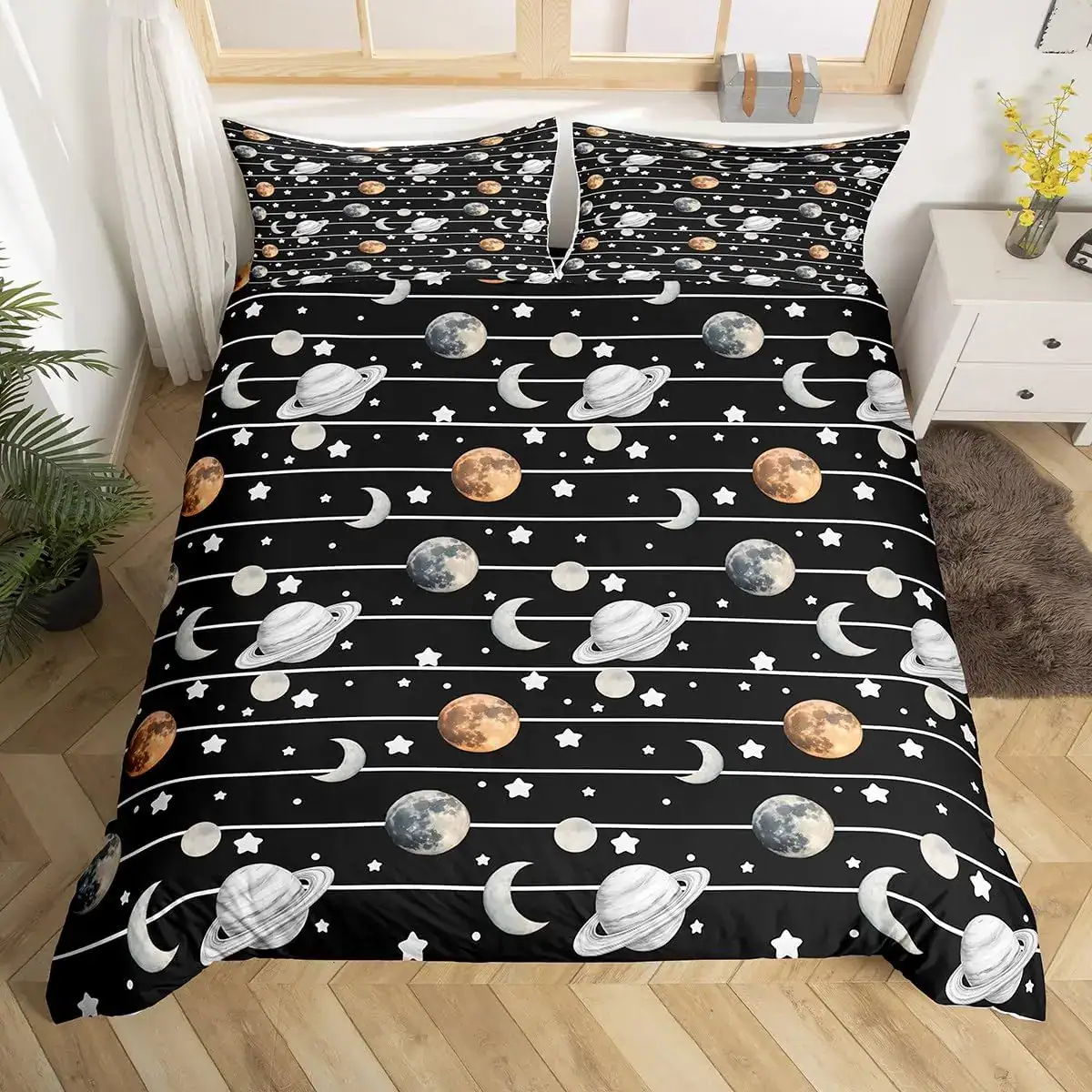 Space-themed bedspread with planets and moons design Space-themed bedspread featuring planets, moons, and stars in a black background for a cosmic bedroom look.