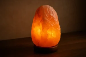Warm glow Himalayan salt lamp on wooden surface, creating a cozy and relaxing atmosphere. Perfect for home decor and ambient lighting.
