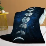 A cozy blanket featuring the moon phases set against a starry galaxy background, perfect for space enthusiasts and educational purposes.