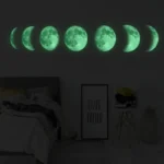 Illuminated moon phases wall art with green glow, showcasing the lunar cycle from new moon to full moon, perfect for astronomy enthusiasts and modern home decor.
