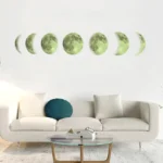 Artistic wall decor featuring the different phases of the moon, displayed above a modern white sofa in a stylish living room.