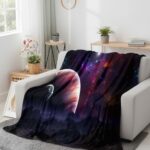 Cozy galaxy-themed throw blanket draped over a white sofa in a bright living room, featuring vibrant nebula and star patterns. Perfect for space enthusiasts and home decor.