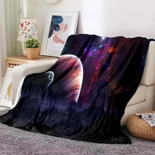Soft throw blanket featuring a vibrant galaxy and space design, perfect for adding a cosmic touch to your living room or bedroom decor.