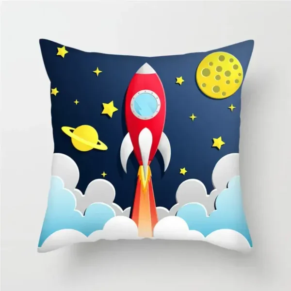 A space-themed decorative pillow featuring a colorful rocket launching into space, surrounded by stars, planets, and clouds on a dark blue background.