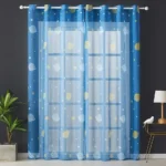 Bright blue curtains with moon and star patterns, perfect for a child's bedroom or science-themed decor.
