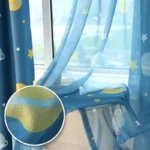 Blue starry sky-themed bed canopy with moon and star patterns, ideal for children's bedrooms or play areas.