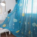Bright blue bed canopy with planets, stars, and moons design for children's bedrooms.