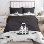Astronaut bed linen set featuring a space scene with moon, stars, and an astronaut sitting on a bench, ideal for children's bedrooms and space enthusiasts.
