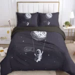 Astronaut and moon illustration on black space-themed bed linen, featuring a cute astronaut floating with a speech bubble saying "HELLO!" and celestial details.