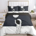 A space-themed bedding set featuring an astronaut holding a balloon with a moon design, set against a dark night sky background.