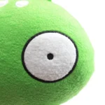 Cute green plush alien toy with one large eye, perfect for science-themed decor and educational play.
