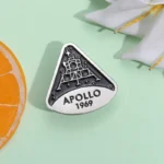 Vintage Apollo 1969 mission pin featuring a space shuttle design, commemorating the historic moon landing. Perfect for space enthusiasts and collectors.