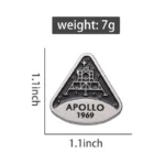 Small Apollo 11 lunar module badge with engraved details, measuring 1.1 inches by 1 inch, weighing 7 grams, symbolizing the historic moon landing of 1969.