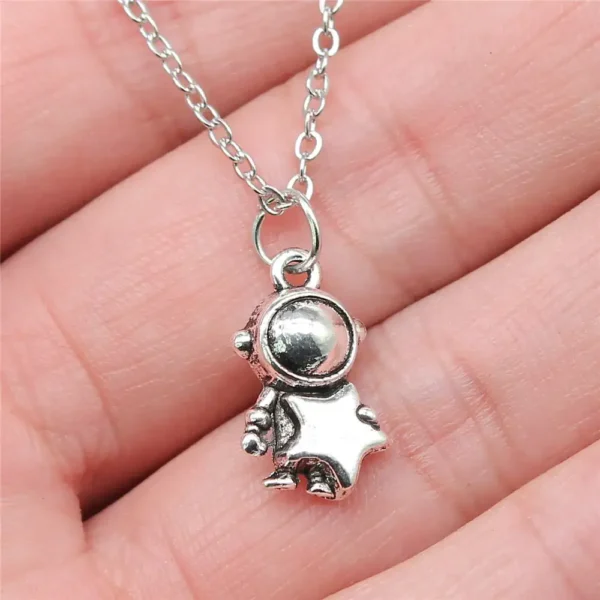 Silver space explorer pendant necklace featuring a cute astronaut charm on a delicate chain, perfect for science enthusiasts and space lovers.