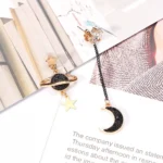 Elegant moon and planet earrings featuring black and gold accents, perfect for celestial-themed jewelry lovers and adding a touch of cosmic charm to any outfit.