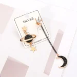 Elegant celestial-themed silver earrings featuring moon and star charms with black glitter accents, perfect for space lovers and fashion enthusiasts.