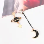 Elegant celestial-themed earrings featuring stars, a planet with rings, and a crescent moon with black glitter accents, perfect for space lovers and fashion enthusiasts.
