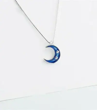 A celestial-themed necklace featuring a blue crescent moon with embedded stars, perfect for science lovers and astronomy enthusiasts.