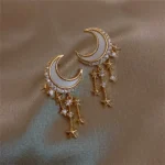 Elegant celestial-themed jewelry featuring crescent moon and star charms with sparkling rhinestones.