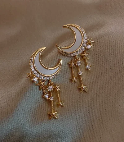 Elegant celestial-themed jewelry featuring crescent moon and star charms with sparkling rhinestones.