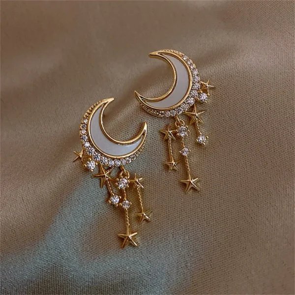 Elegant celestial-themed jewelry featuring crescent moon and star charms with sparkling rhinestones.