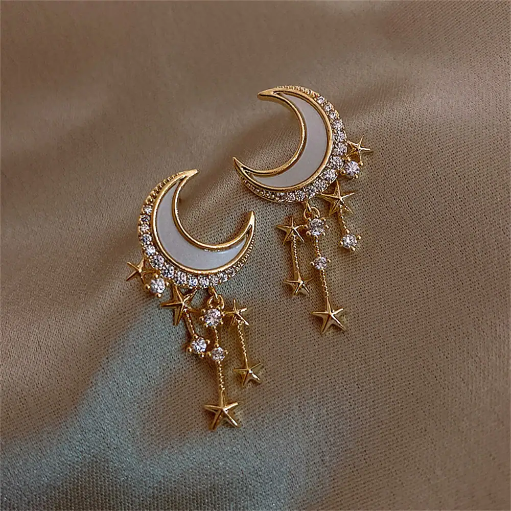 Elegant celestial-themed jewelry featuring crescent moon and star charms with sparkling rhinestones.