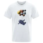 White T-shirt featuring a graphic of an astronaut holding balloons shaped like planets and celestial bodies, creating a fun space exploration design.
