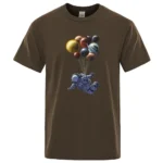 Astronaut floating with planets and stars graphic on a brown T-shirt, perfect for space enthusiasts and science lovers.