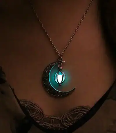 A glowing moon and lantern pendant necklace with a mystical design, perfect for fans of celestial and fantasy jewelry.