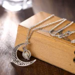 Elegant moon and star pendant necklace with intricate filigree design, perfect for astrology enthusiasts and jewelry lovers.