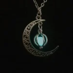 Elegant moon and lantern pendant necklace with intricate design and glowing blue light.