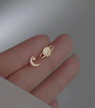 Elegant gold ring featuring a star and moon design with sparkling stones, inspired by celestial themes.