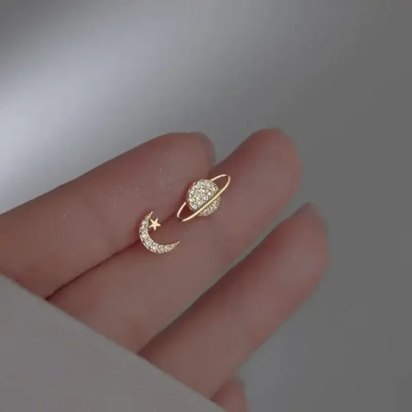 Elegant gold ring featuring a star and moon design with sparkling stones, inspired by celestial themes.