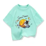 Children's mint green T-shirt featuring a fun space-themed design with a cartoon astronaut, planets, and rockets, perfect for kids interested in science and space exploration.