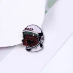 Astronaut helmet pin with a bear face design, perfect for science enthusiasts and collectors.