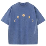 Blue T-shirt featuring a moon phase design with different lunar phases arranged in a semi-circle pattern.