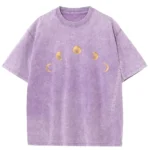 Purple cotton T-shirt featuring a moon phases design with gold-colored moon illustrations across the chest. Perfect for astronomy enthusiasts and casual wear.