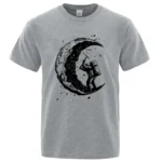 Astronaut floating near a crescent moon graphic on a casual gray T-shirt, perfect for science lovers and space exploration fans.