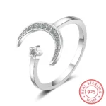 Elegant moon and star design silver ring with embedded cubic zirconia stones, perfect for celestial-themed jewelry collections.