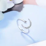 Elegant silver ring featuring a crescent moon adorned with sparkling crystals and a tiny star accent. Perfect for astrology lovers or as a unique fashion accessory.