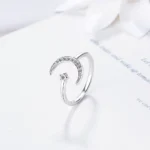 Elegant silver ring featuring a crescent moon and star design with embedded crystals, perfect for jewelry lovers.