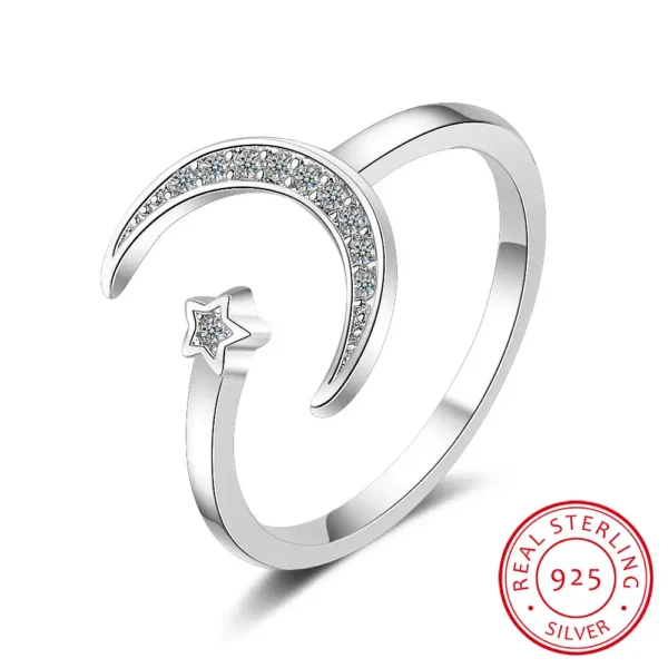 Elegant moon and star design silver ring with embedded cubic zirconia stones, perfect for celestial-themed jewelry collections.