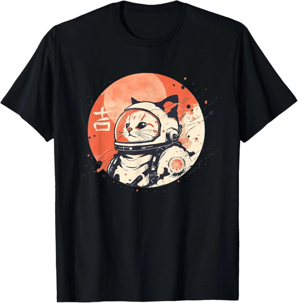 Space-themed cat wearing an astronaut helmet on a black T-shirt, with a large orange moon in the background and artistic splashes.