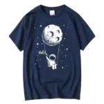 Navy blue kids' T-shirt featuring a playful astronaut holding a string attached to a moon with stars, perfect for space enthusiasts and young explorers.
